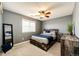 Comfortable bedroom with a wooden bedframe, ceiling fan, carpeted floors, and a window at 4968 Montvale Dr, Highlands Ranch, CO 80130