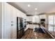 Bright kitchen with stainless steel appliances, white cabinetry, and granite countertops at 4968 Montvale Dr, Highlands Ranch, CO 80130