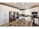 Well-lit kitchen with stainless steel appliances, granite countertops, and ample storage at 4968 Montvale Dr, Highlands Ranch, CO 80130