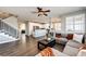 Inviting living room showcasing hardwood floors, a comfortable sectional, and an open floor plan at 4968 Montvale Dr, Highlands Ranch, CO 80130