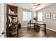 Cozy home office with a large window, ceiling fan, and a shelving unit, perfect for work at 4968 Montvale Dr, Highlands Ranch, CO 80130