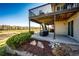 View of the home's patio area with furniture and manicured landscaping. The lower level is a walkout at 4968 Montvale Dr, Highlands Ranch, CO 80130