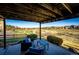 Relaxing patio with furniture and views of the open area and walking path behind the home at 4968 Montvale Dr, Highlands Ranch, CO 80130