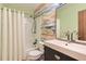 Bathroom featuring a shower with white curtain, painted wall with colored stripes and modern sink at 15912 E Dakota Pl # C, Aurora, CO 80017