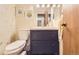 Stylish half bathroom with navy vanity, modern fixtures, and lemon-themed artwork at 15912 E Dakota Pl # C, Aurora, CO 80017