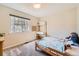 Bright bedroom with large window, neutral carpet, and a small wooden bed with desk and shelves at 15912 E Dakota Pl # C, Aurora, CO 80017