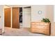 Bedroom with wood dresser, closet and hanging storage, and gray carpet for a comfortable living space at 15912 E Dakota Pl # C, Aurora, CO 80017