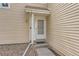 Close-up of the light and airy front door with a small porch and beige siding at 15912 E Dakota Pl # C, Aurora, CO 80017