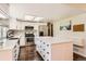 Modern kitchen boasts white cabinets, stainless steel appliances, and a spacious center island at 15912 E Dakota Pl # C, Aurora, CO 80017