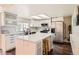 Bright, modern kitchen with white cabinetry, a center island, and stainless steel appliances for an updated look at 15912 E Dakota Pl # C, Aurora, CO 80017