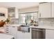 The kitchen features white cabinetry, stainless steel appliances, and a large window at 15912 E Dakota Pl # C, Aurora, CO 80017