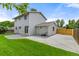 Spacious backyard featuring a well-maintained lawn, concrete patio, and detached garage at 3193 W 134Th Cir, Broomfield, CO 80020