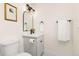 A well-lit bathroom featuring grey vanity, modern light fixture and framed artwork at 3193 W 134Th Cir, Broomfield, CO 80020