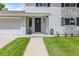 Inviting front entrance with manicured lawn and black door at a two-story home at 3193 W 134Th Cir, Broomfield, CO 80020