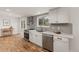 Beautiful kitchen features stainless appliances, white cabinets and backsplash at 3193 W 134Th Cir, Broomfield, CO 80020