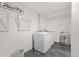 Bright laundry room with modern washer and dryer, stainless steel sink and drying rack at 3193 W 134Th Cir, Broomfield, CO 80020