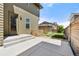 Charming backyard with concrete patio, grass area, and partial fencing, perfect for outdoor enjoyment at 5988 N Boston St, Denver, CO 80238