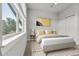 Bedroom featuring a large window and neutral decor at 5988 N Boston St, Denver, CO 80238