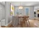 Charming dining area with hardwood floors and stylish light fixture, next to outdoor patio at 5988 N Boston St, Denver, CO 80238