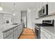 Well-equipped kitchen with granite countertops, stainless steel appliances, and hardwood floors at 5988 N Boston St, Denver, CO 80238