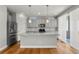 Modern kitchen with stainless steel appliances, a large island, and hardwood floors at 5988 N Boston St, Denver, CO 80238
