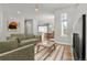 Open-concept living room with hardwood floors, modern furniture, and ample natural light at 5988 N Boston St, Denver, CO 80238