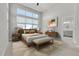 A serene main bedroom with a large window and ensuite bathroom access at 5988 N Boston St, Denver, CO 80238