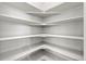 A corner walk-in pantry featuring white shelving at 5988 N Boston St, Denver, CO 80238