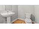 A stylish powder room with a pedestal sink and modern toilet at 5988 N Boston St, Denver, CO 80238