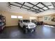 Interior of a well-lit garage featuring epoxy floors and ample space for vehicles and equipment at 17401 Snowcreek Ln, Morrison, CO 80465