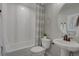 Well-lit bathroom featuring modern fixtures, a pedestal sink, and a shower-tub combo at 1152 Sugarloaf Ln, Erie, CO 80516