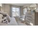 Cozy bedroom with a daybed, a neutral color scheme, and a view of the neighborhood at 1152 Sugarloaf Ln, Erie, CO 80516