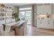 Dining room features a modern chandelier, large sliding doors, and sleek white cabinetry at 1152 Sugarloaf Ln, Erie, CO 80516