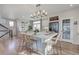 Bright eat-in kitchen features a large center island, stainless steel appliances, and modern pendant lighting at 1152 Sugarloaf Ln, Erie, CO 80516