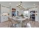 Modern kitchen boasts a large island with bar seating, white cabinetry, and stainless steel appliances at 1152 Sugarloaf Ln, Erie, CO 80516