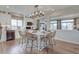 Open-concept kitchen features a center island with barstool seating and stainless steel appliances at 1152 Sugarloaf Ln, Erie, CO 80516