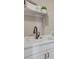 Bright laundry room features a white sink with a bronze faucet and storage space above at 1152 Sugarloaf Ln, Erie, CO 80516