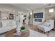 Bright, open-concept living room with fireplace, hardwood floors, and a seamless transition to the kitchen at 1152 Sugarloaf Ln, Erie, CO 80516