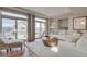 Bright living room featuring hardwood floors, large windows, and modern furnishings at 1152 Sugarloaf Ln, Erie, CO 80516