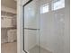 Modern bathroom featuring a sleek glass shower and an organized walk-in closet at 1152 Sugarloaf Ln, Erie, CO 80516