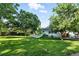 Lush green backyard with mature trees and a well-maintained lawn, offering a private outdoor oasis at 5193 S Flanders Ln, Centennial, CO 80015
