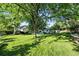 Large backyard featuring mature trees, lush green lawn, and a serene, shaded environment at 5193 S Flanders Ln, Centennial, CO 80015