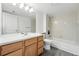 Well-lit bathroom features wood vanity, ample counter space, and tub-shower combo at 5193 S Flanders Ln, Centennial, CO 80015