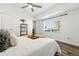 Well-lit bedroom features a ceiling fan, wood floors, and a view of the lush landscaping at 5193 S Flanders Ln, Centennial, CO 80015
