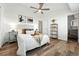 Bright bedroom features modern decor, wood floors, ceiling fan, and ensuite bathroom access at 5193 S Flanders Ln, Centennial, CO 80015