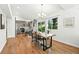 Open dining area featuring hardwood floors, modern chandelier, and sliding glass doors to the backyard at 5193 S Flanders Ln, Centennial, CO 80015