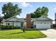 Well-maintained single-Gathering home featuring a two-car garage, a red brick chimney, and lush green lawn at 5193 S Flanders Ln, Centennial, CO 80015
