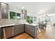 Contemporary kitchen with stainless steel dishwasher, sink, and a view to the dining area at 5193 S Flanders Ln, Centennial, CO 80015