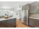 Open concept kitchen with stainless steel refrigerator and a kitchen island at 5193 S Flanders Ln, Centennial, CO 80015