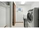 Bright laundry room featuring a washer and dryer, convenient closet and natural light at 5193 S Flanders Ln, Centennial, CO 80015